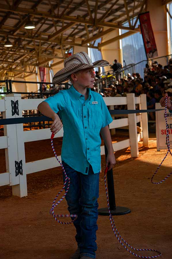 little boy selling lassos in a cowboy hat